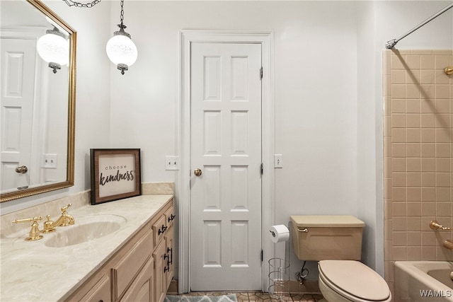 full bathroom with toilet, vanity, and tiled shower / bath combo