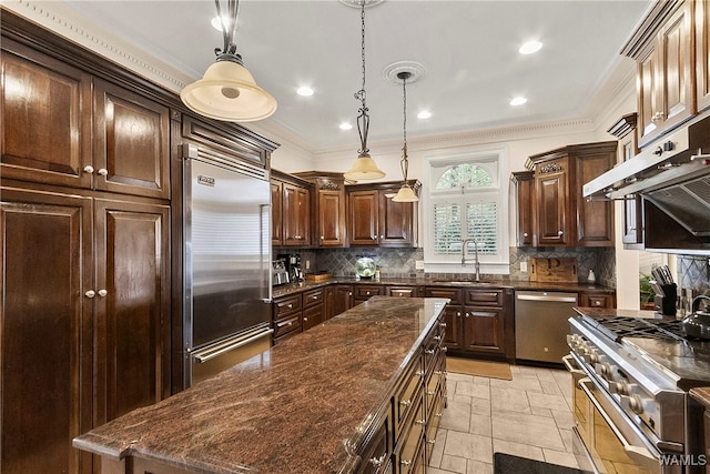 kitchen with ornamental molding, decorative light fixtures, high quality appliances, and sink