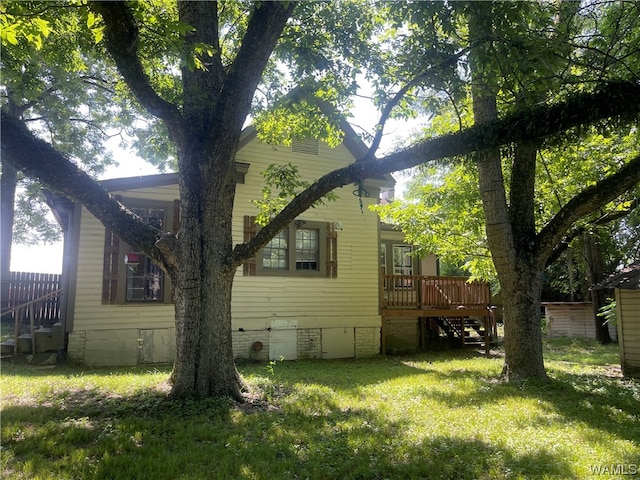 view of home's exterior featuring a yard and a wooden deck