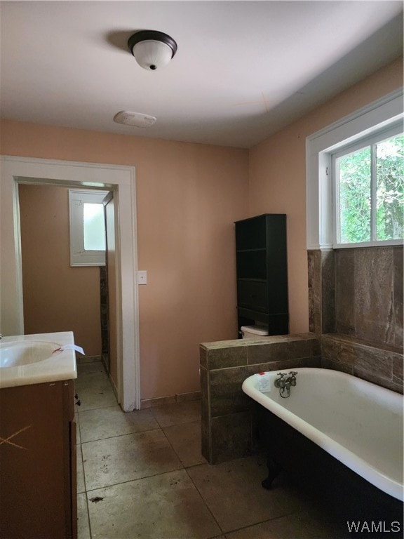 bathroom featuring vanity and a tub to relax in