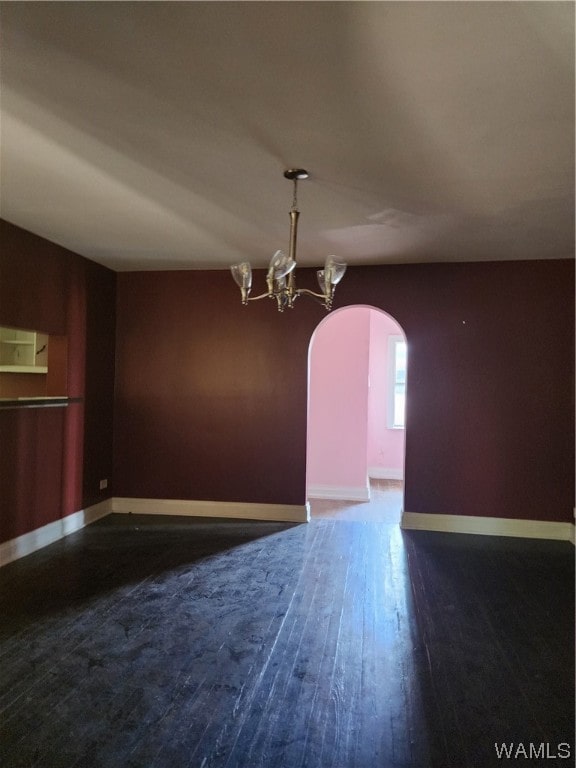 unfurnished dining area with a chandelier and dark wood-type flooring