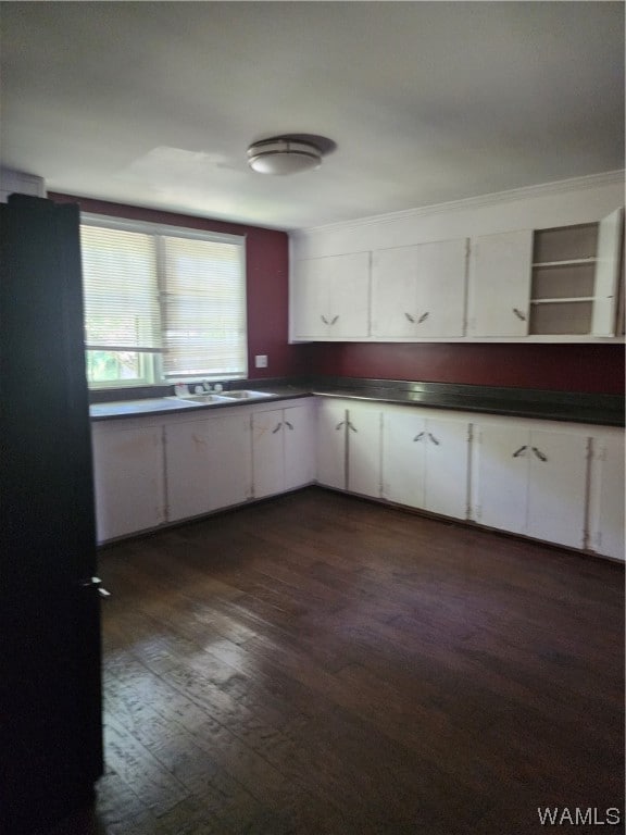 kitchen with white cabinets, dark hardwood / wood-style floors, and sink