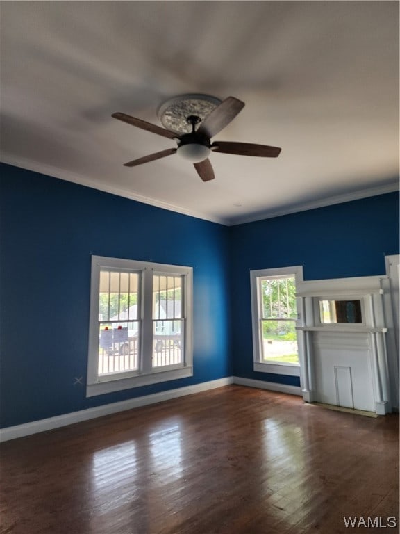 empty room with dark hardwood / wood-style flooring, ceiling fan, and ornamental molding