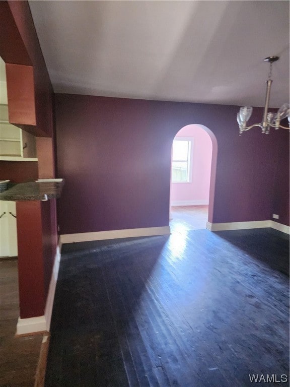 unfurnished living room with dark hardwood / wood-style flooring