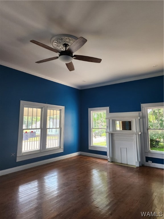 unfurnished living room featuring dark hardwood / wood-style floors, ceiling fan, and ornamental molding