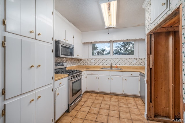 kitchen with sink, white cabinets, and stainless steel appliances