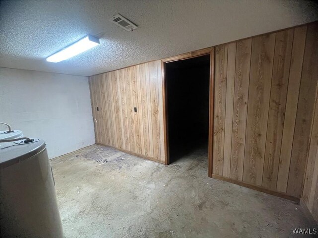 10882 Tingle Tangle Rd, Vance, AL 35490 - basement with a textured ceiling and wooden walls