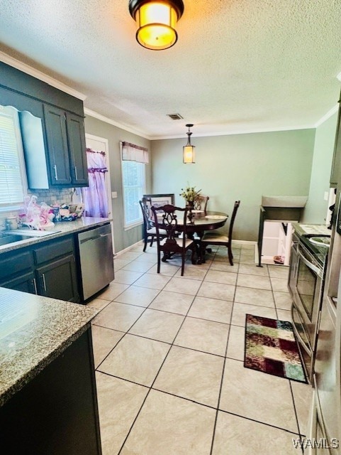 kitchen featuring appliances with stainless steel finishes, crown molding, a textured ceiling, light tile patterned floors, and a sink