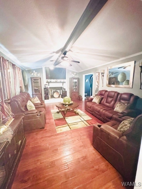 living room featuring wood finished floors, ceiling fan, and crown molding