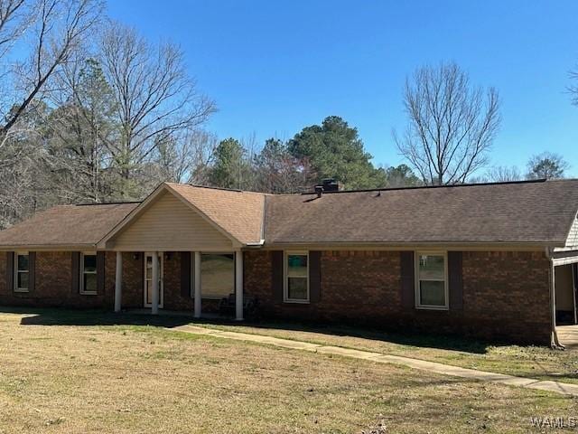 single story home featuring a front lawn and brick siding