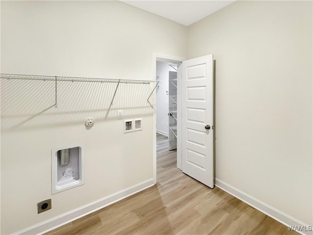 laundry area featuring gas dryer hookup, electric dryer hookup, washer hookup, and light hardwood / wood-style floors