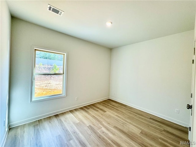 unfurnished room with light hardwood / wood-style floors