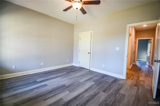 unfurnished bedroom featuring ceiling fan and dark hardwood / wood-style floors