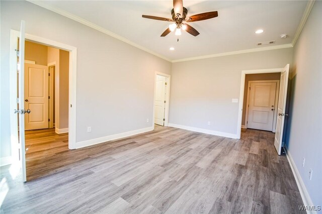 unfurnished bedroom with ceiling fan, ornamental molding, and light hardwood / wood-style flooring