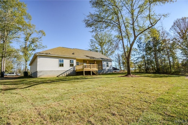 back of property with a yard, a deck, and stairs