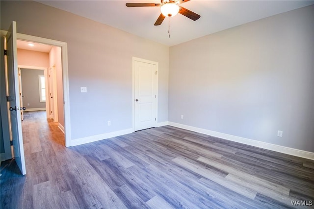 unfurnished bedroom featuring dark wood-type flooring and ceiling fan