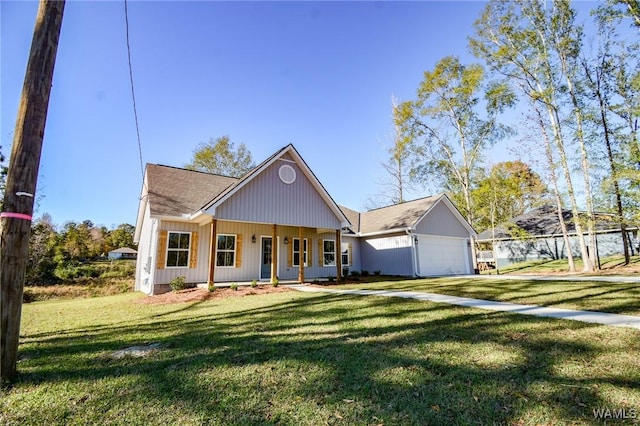 view of front of home featuring covered porch, a front yard, and a garage