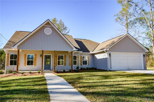 view of front of home with a front yard, a garage, and covered porch