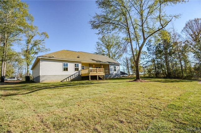 rear view of property with a yard and a wooden deck