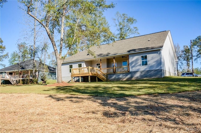 back of house featuring a lawn and a wooden deck