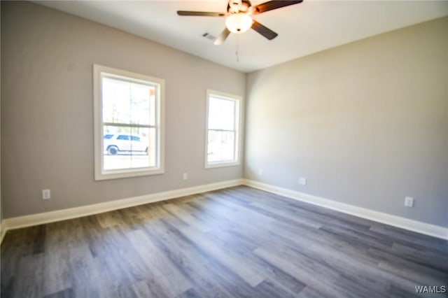 empty room featuring ceiling fan and dark hardwood / wood-style flooring