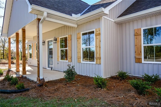 view of exterior entry with a patio area