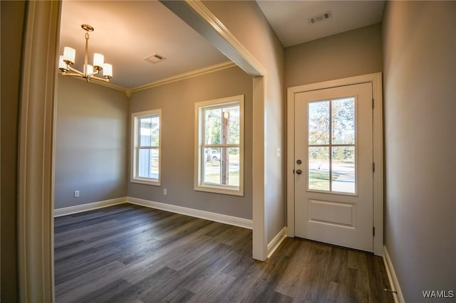 doorway to outside featuring a chandelier, ornamental molding, and dark wood-type flooring