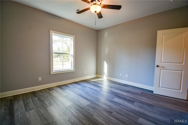 empty room with ceiling fan and dark hardwood / wood-style floors