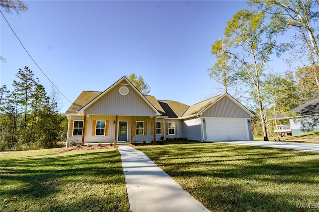 view of front of house with covered porch, a front yard, and a garage