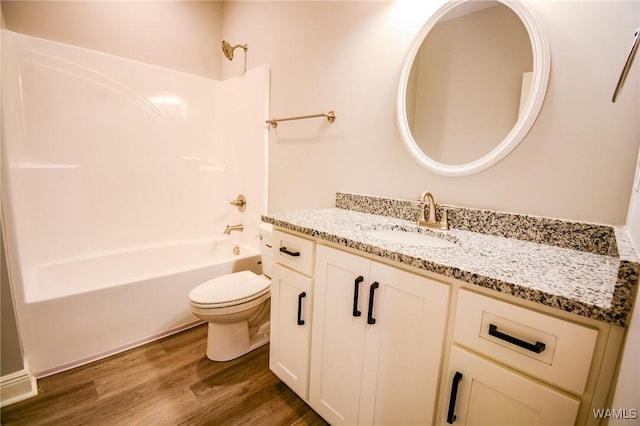 full bathroom with shower / washtub combination, hardwood / wood-style flooring, vanity, and toilet