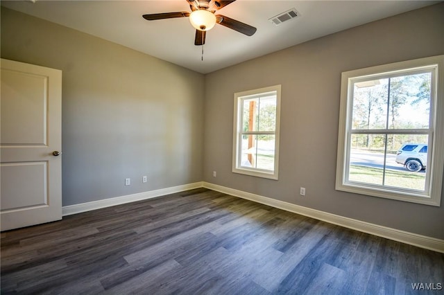 unfurnished room with ceiling fan and dark wood-type flooring