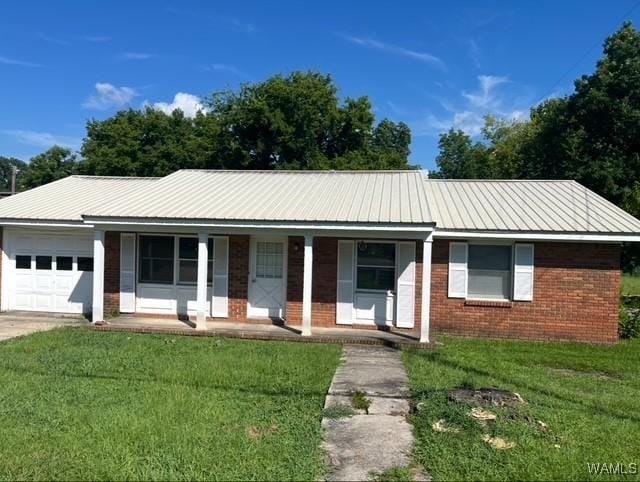 2370 Main St, Brent, AL 35034 - ranch-style home featuring a garage, covered porch, a front lawn, brick siding, and a metal roof