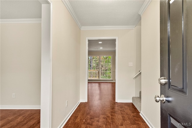 entrance foyer with a textured ceiling, dark hardwood / wood-style floors, and ornamental molding