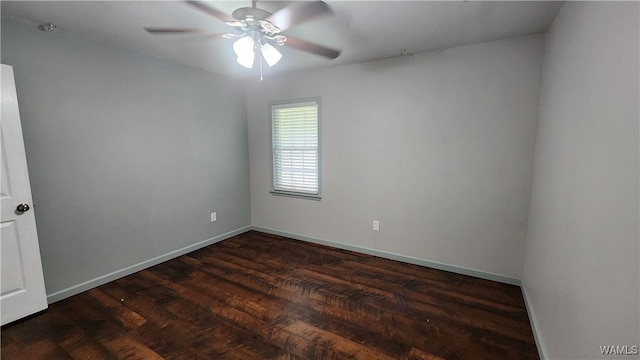 empty room with ceiling fan and dark wood-type flooring