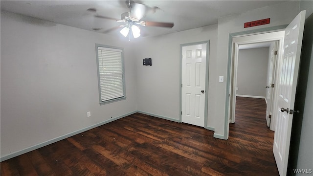 unfurnished room featuring ceiling fan and dark wood-type flooring