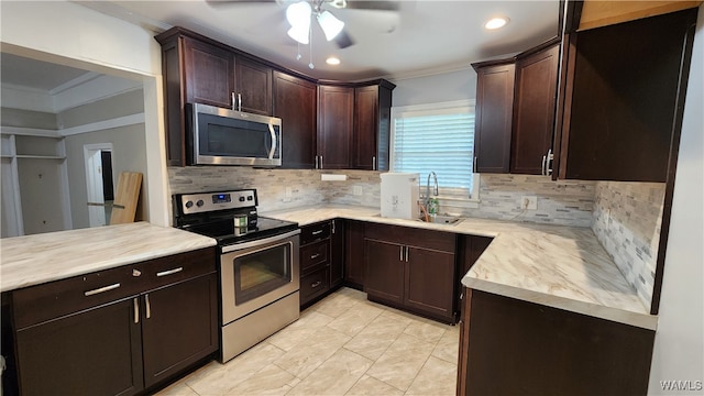 kitchen with dark brown cabinetry, crown molding, sink, and stainless steel appliances