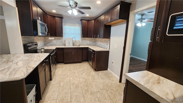 kitchen featuring ceiling fan, sink, tasteful backsplash, dark brown cabinets, and appliances with stainless steel finishes