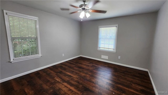 spare room with ceiling fan and dark wood-type flooring