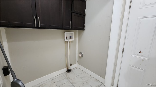 clothes washing area featuring cabinets and hookup for a washing machine