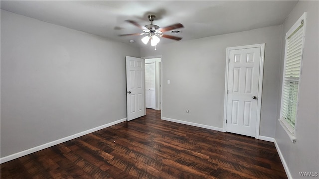 unfurnished bedroom featuring ceiling fan and dark hardwood / wood-style flooring