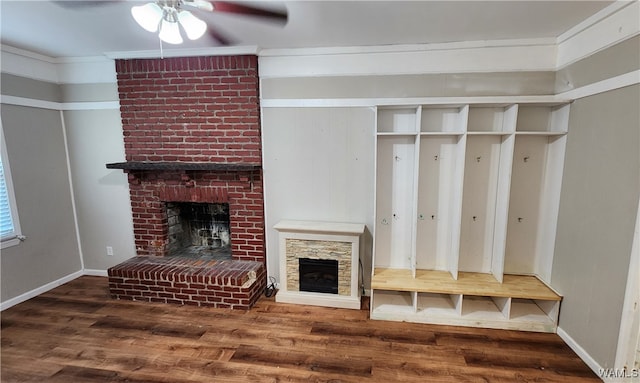 mudroom with a fireplace, crown molding, ceiling fan, and dark wood-type flooring