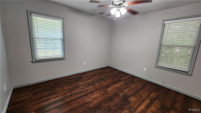 spare room with dark hardwood / wood-style flooring and ceiling fan