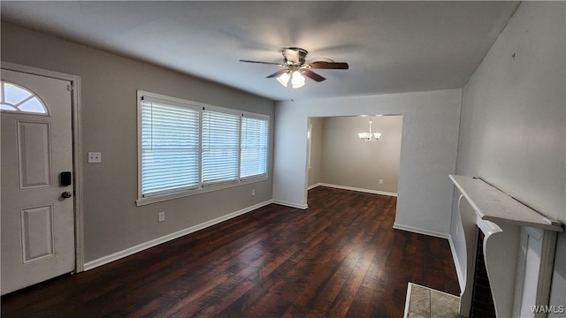 foyer entrance featuring dark hardwood / wood-style floors and ceiling fan with notable chandelier