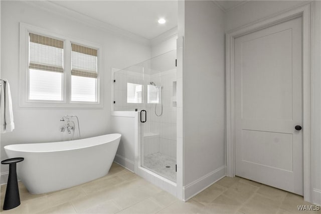 5377 Alexander Ave, Tuscaloosa, AL 35406 - full bath with a soaking tub, a shower stall, ornamental molding, and tile patterned floors