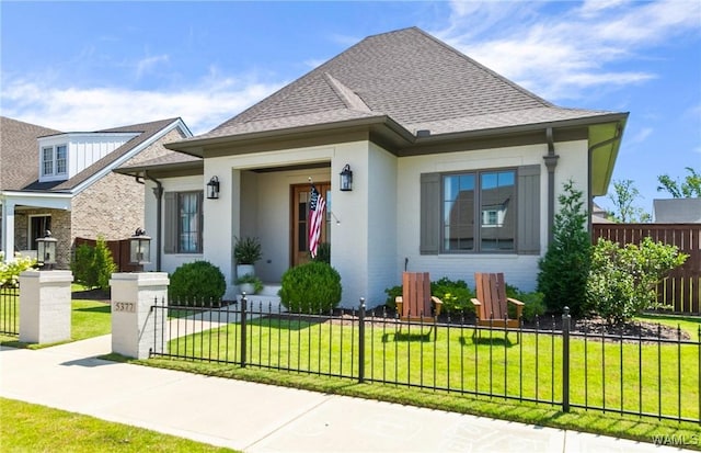 5377 Alexander Ave, Tuscaloosa, AL 35406 - view of front facade featuring a fenced front yard, roof with shingles, and brick siding