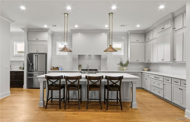 5377 Alexander Ave, Tuscaloosa, AL 35406 - kitchen with high end fridge, an island with sink, light countertops, a kitchen bar, and recessed lighting