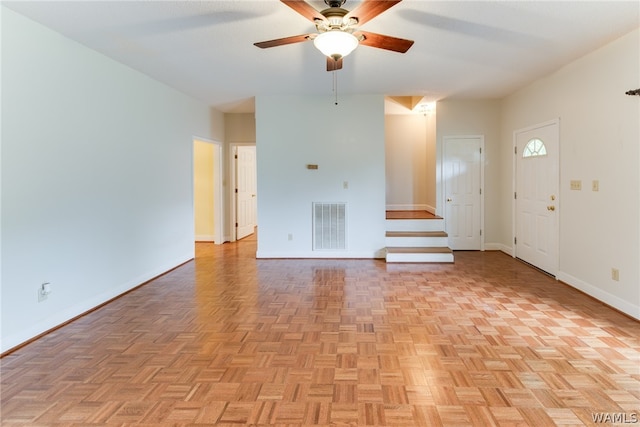 unfurnished living room with ceiling fan and light parquet floors