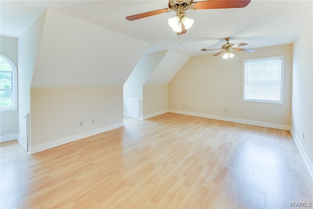 bonus room with ceiling fan, light hardwood / wood-style floors, and vaulted ceiling