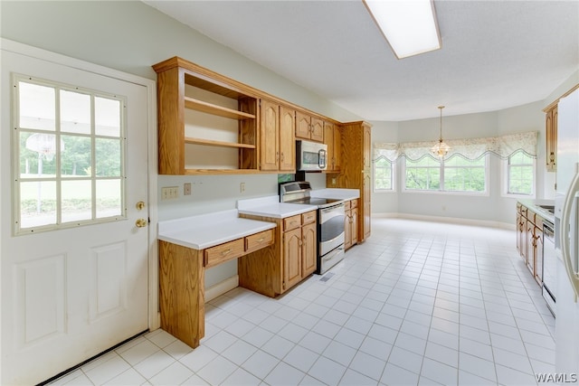 kitchen featuring a chandelier, hanging light fixtures, light tile patterned floors, and stainless steel appliances