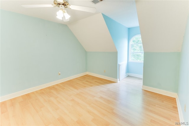 additional living space featuring light hardwood / wood-style flooring, ceiling fan, and lofted ceiling